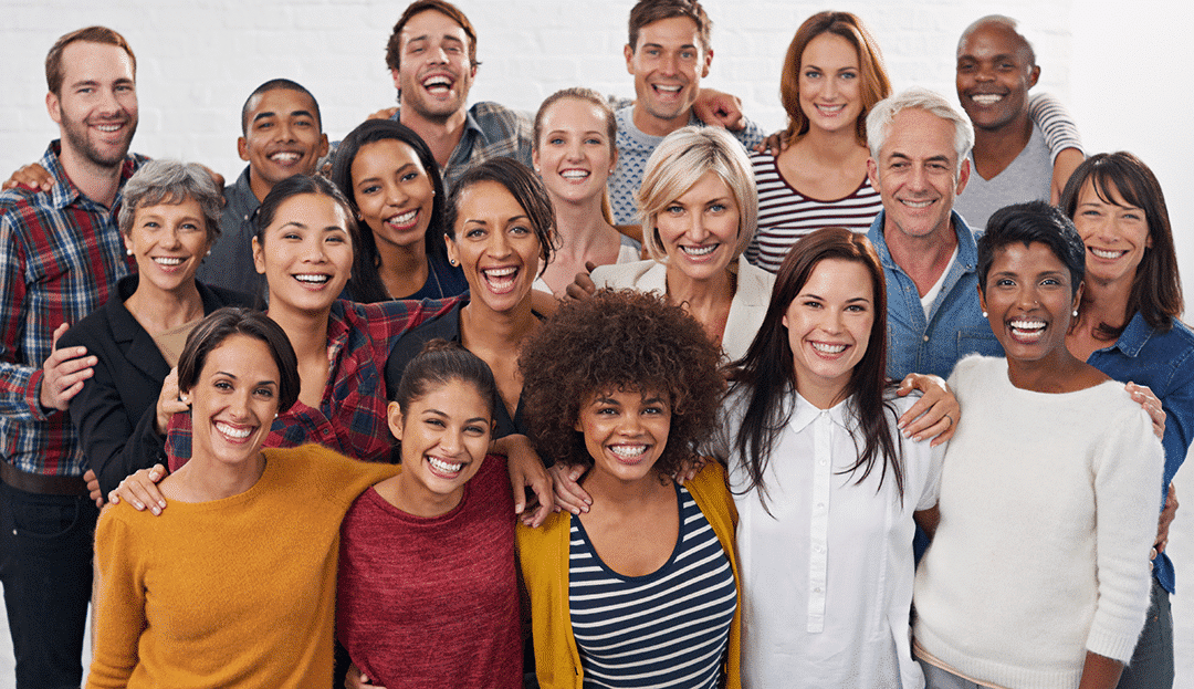 Happy diverse coworkers embracing eachother representing creating an inclusive workplace culture